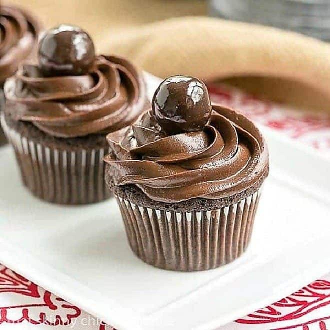 Perfect Chocolate Cupcakes lined up on a white tray.
