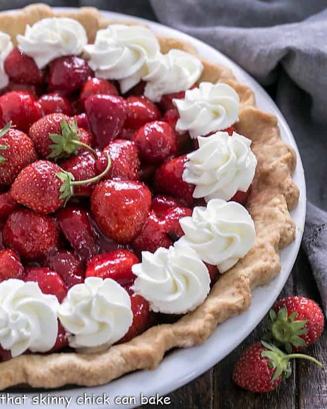 Overhead view of half a Fresh Strawberry Pie in a white pie plate.