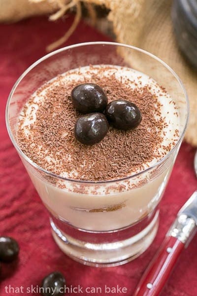 Classic Tiramisu - A twist on the classic tiramisu with Kahlua and rum Classic Tiramisu in a cocktail glass garnished with chocolate covered coffee beans.