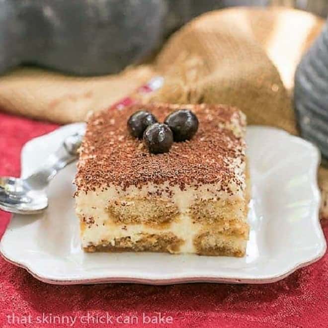 Classic Tiramisu - A twist on the classic tiramisu with Kahlua and rum Slice of Classic Tiramisu on a square white plate.