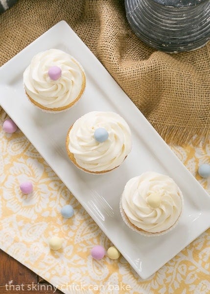 Buttercream Topped Vanilla Cupcakes - Delightfully delicious vanilla cupcakes! Overhead view of Buttercream Topped Vanilla Cupcakes.