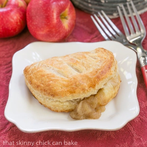 Chaussons aux Pommes with filling seeping out.