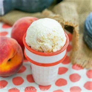 Fresh Peach Ice Cream in a white and orange ceramic cone
