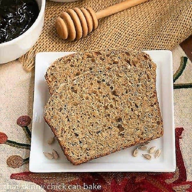 Sunflower Whole Wheat Bread - A whole wheat quick bread with oats, buttermilk and sunflower seeds! Sunflower Whole Wheat Bread on a white plate