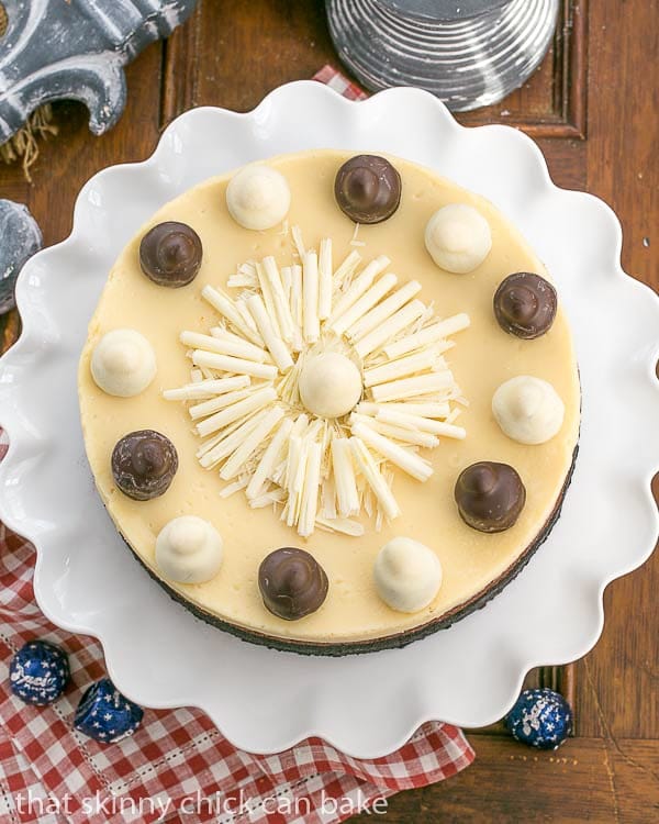 Layered Chocolate Cheesecake on a white ruffled cake stand to end the holiday feast.