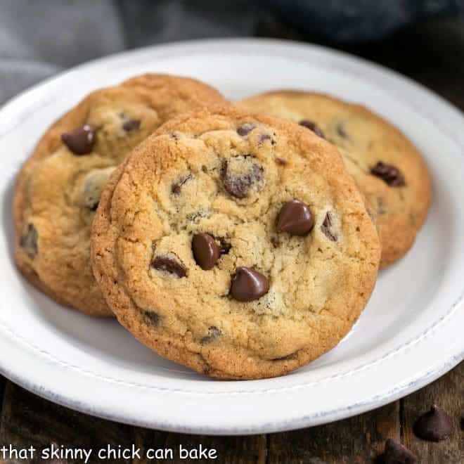 Thin Chewy Chocolate Chip Cookies - For those times you want a bigger, thinner, chewy cookie! Thin and Chewy Chocolate Chip Cookies on a round white plate