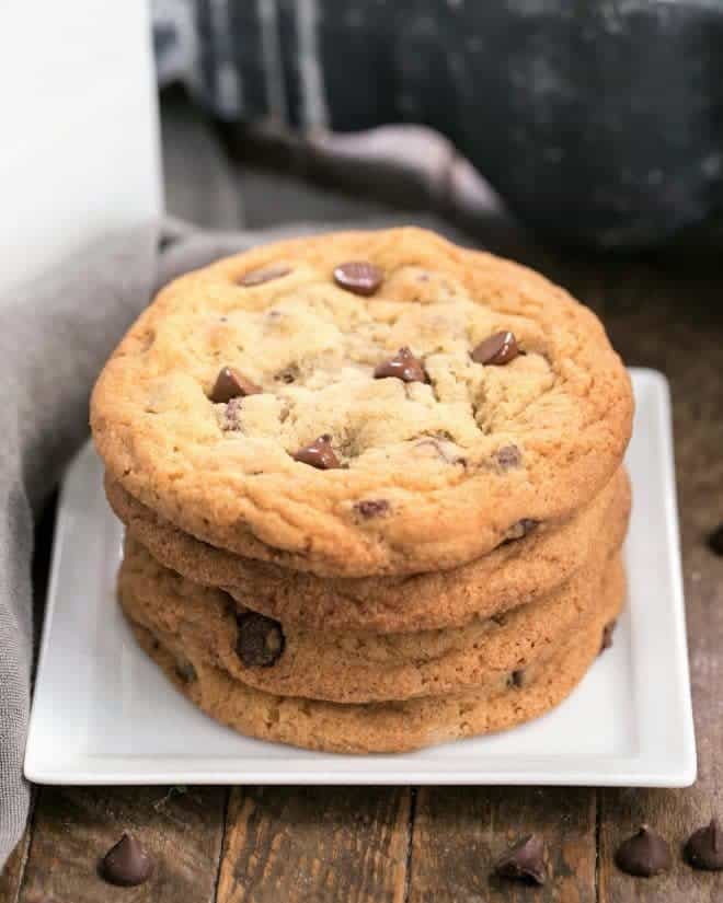 Thin Chewy Chocolate Chip Cookies - For those times you want a bigger, thinner, chewy cookie! A stack of Thin Chewy Chocolate Chip Cookies on a square plate