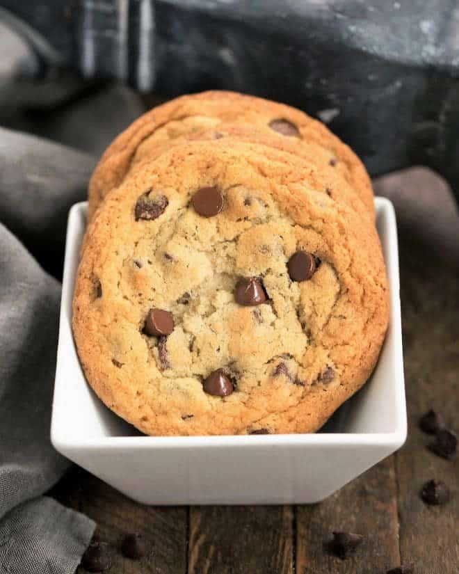 Thin Chewy Chocolate Chip Cookies - For those times you want a bigger, thinner, chewy cookie! Thin Chewy Chocolate Chip Cookies in a square white bowl