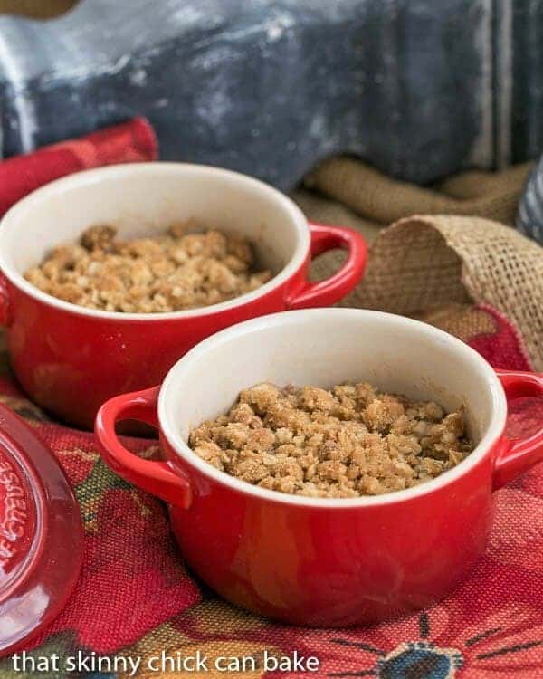 2 bowls of Apple Pear Crisp in small red crocks.