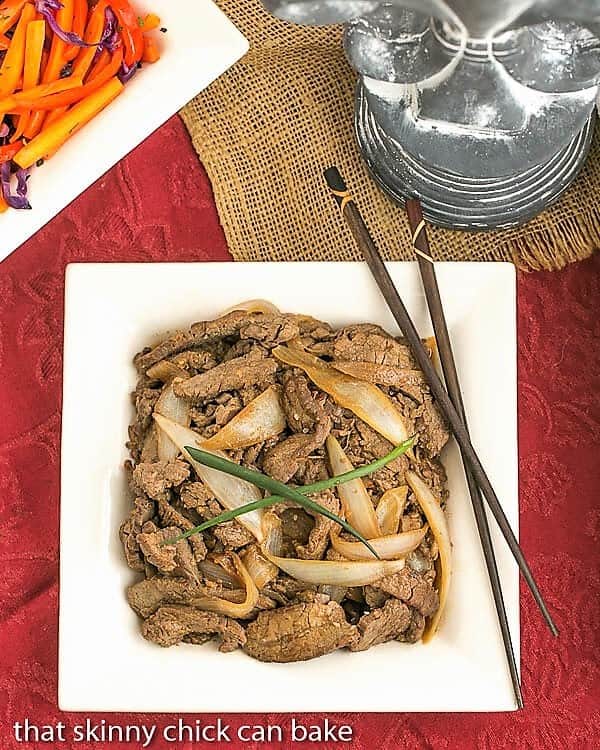 Beef Bulgogi on a square white plate with chopsticks