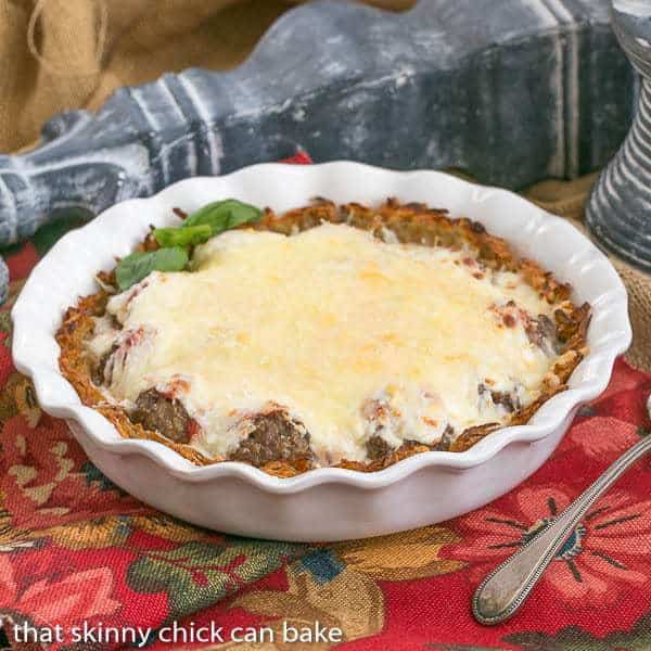 Italian Poutine Pie in a white ceramic pie plate.