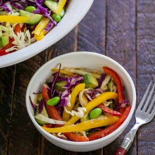 Overhead view of small bowl of Thai salad next to the serving bowl