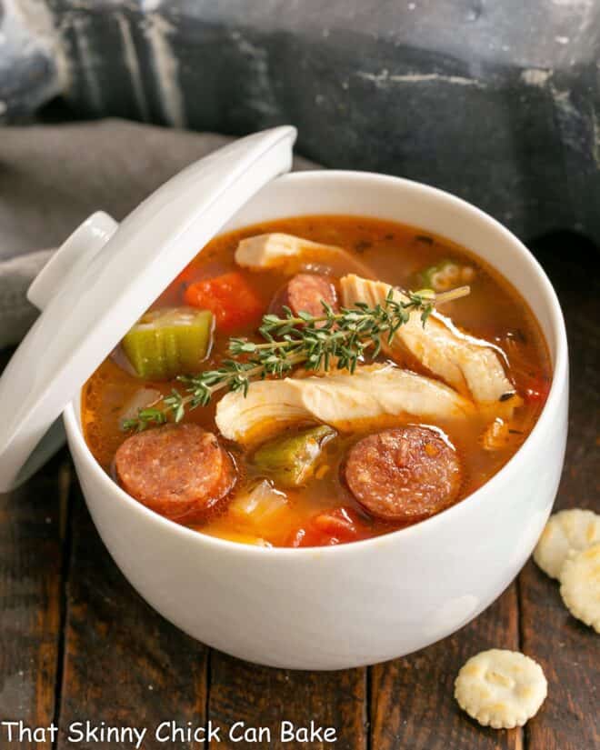 Jambalaya soup in a tureen with a lid.