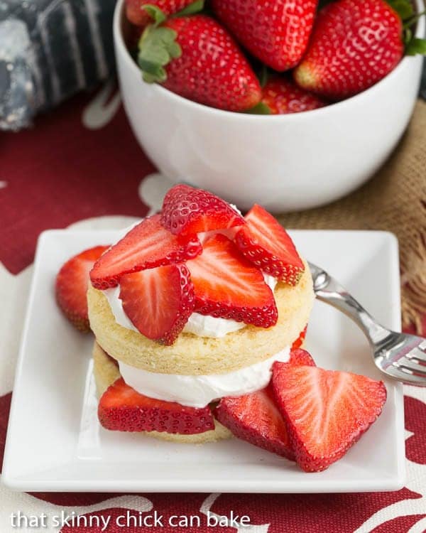 a plate of fresh Strawberry Shortcakes with Olive Oil Cake rounds.