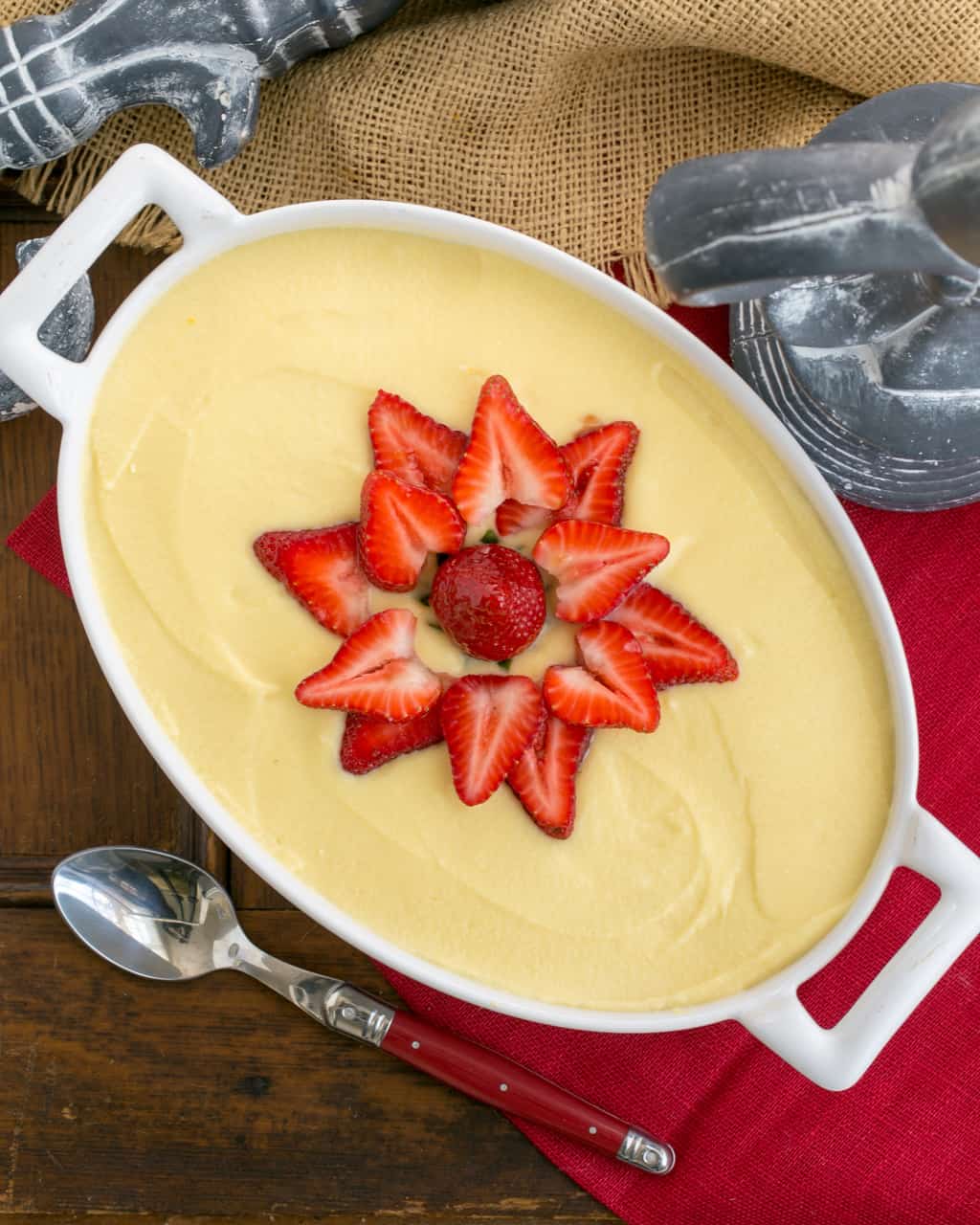 Berry Tiramisu with Grand Marnier in an oval casserole with a garnish of fresh strawberry slices.