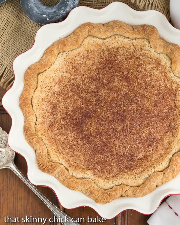 Hoosier Sugar Cream Pie -A classic dessert in Indiana made with sugar, cream and vanilla! Sugar Cream Pie in a red and white ceramic pie plate from above.