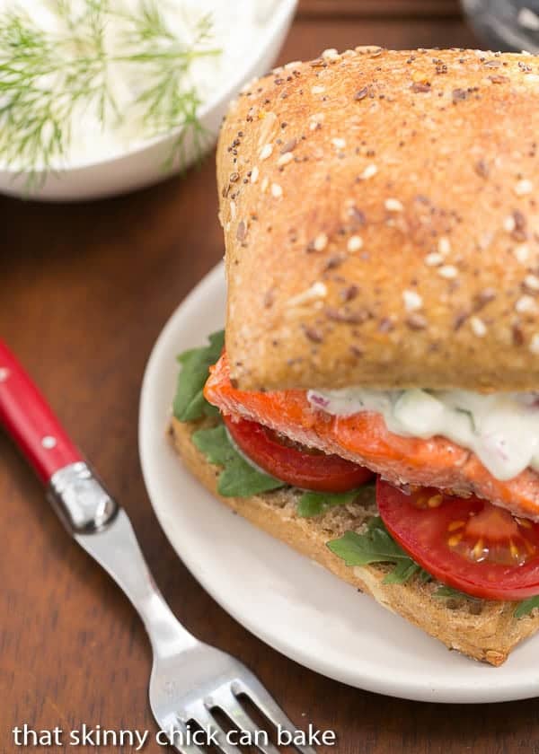 Open-Faced Salmon Sandwiches with Herb Cucumber Relish- This is one heck of a marvelous sandwich!!! Open-Faced Salmon Sandwich with Herb Cucumber Relish on a round white plate.