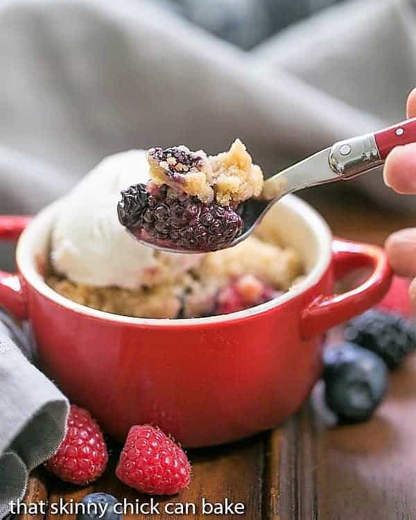 A spoon with a smalll scoop removed from an Individual Berry Crisp.