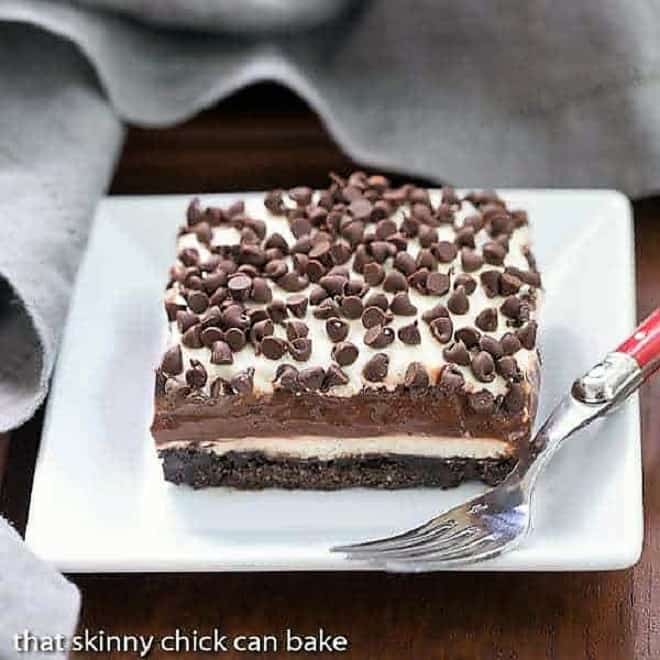 Chocolate Lasagna - A cool, decadent layered chocolate extravaganza! Chocolate Lasagna slice on a square white plate