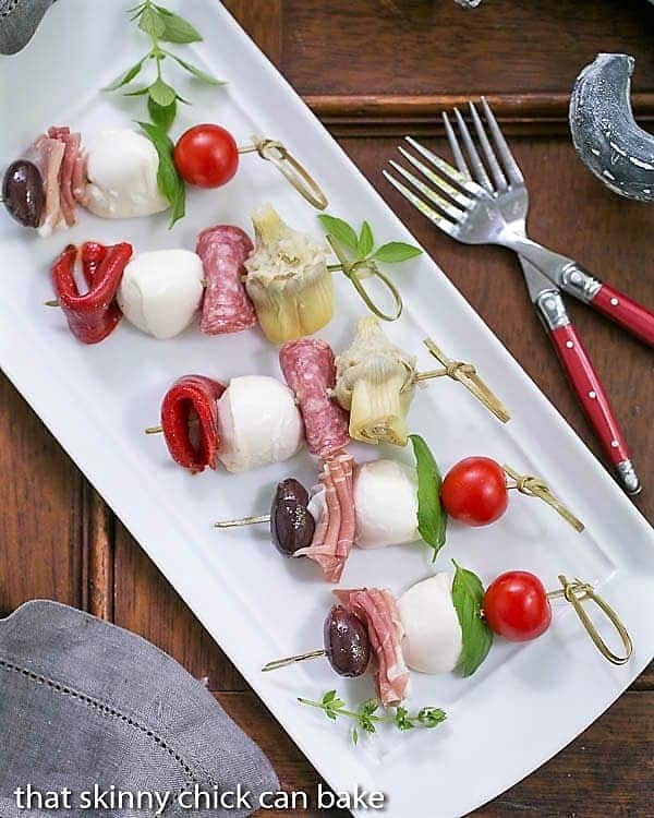 Antipasto Skewers - An easy twist on the Italian appetizer Antipasto Skewers on a rectangular white tray.