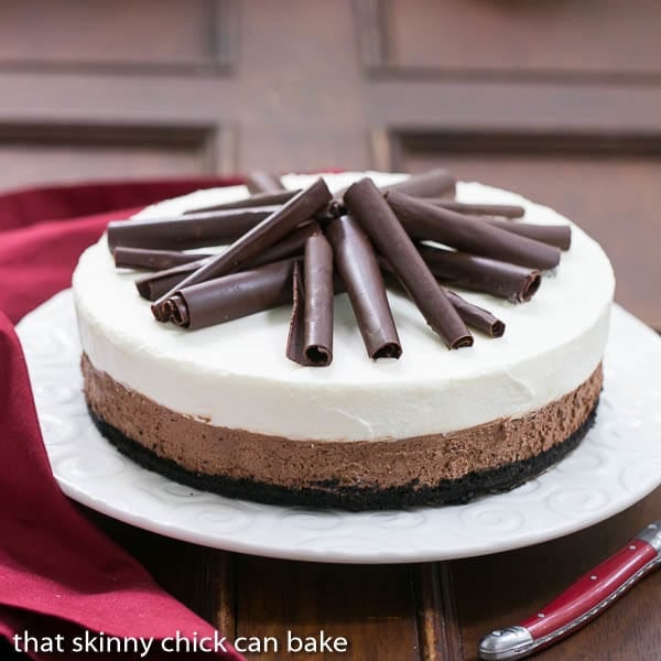 Triple Chocolate Mousse Pie - A dreamy pie topped with both dark and white chocolate mousse Triple Chocolate Mousse Pie on a serving plate topped with chocolate curls.