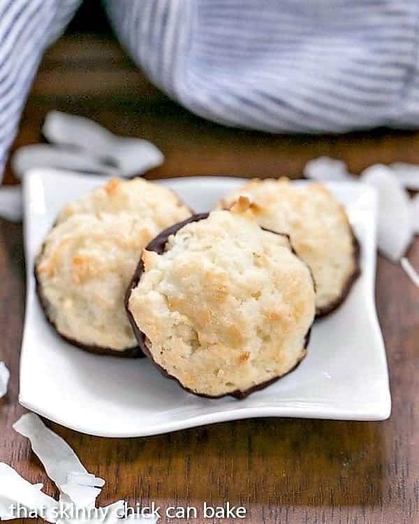 Coconut Macaroons - Light and scrumptious with a crisp exterior and chewy middles! Coconut Macaroons on a white square plate.