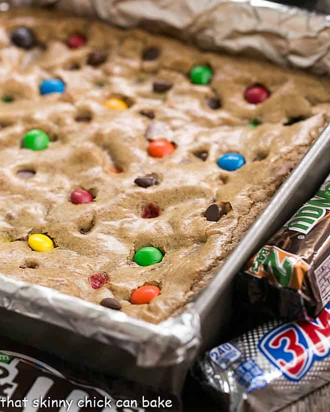 Candy Bar Blondies - The perfect way to use up any leftover candy! Candy Bar Blondies in a baking pan,
