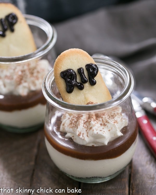 Fudgy Tombstone Parfaits | Luscious layers of Oreo crumbs, cheesecake filling and fudge sauce make with a tombstone cookie make for a terrific Halloween dessert!