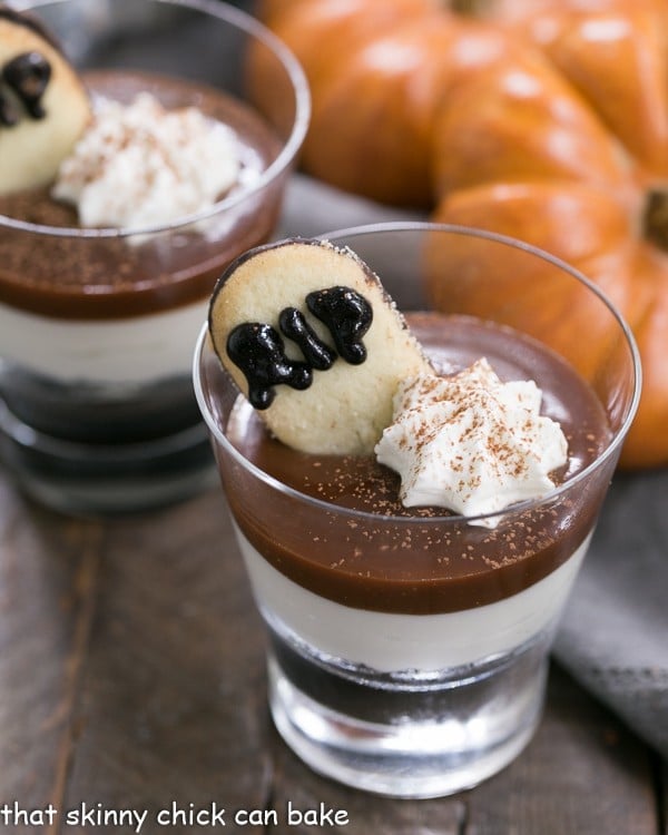 Fudgy Tombstone Parfaits | Luscious layers of Oreo crumbs, cheesecake filling and fudge sauce make with a tombstone cookie make for a terrific Halloween dessert!