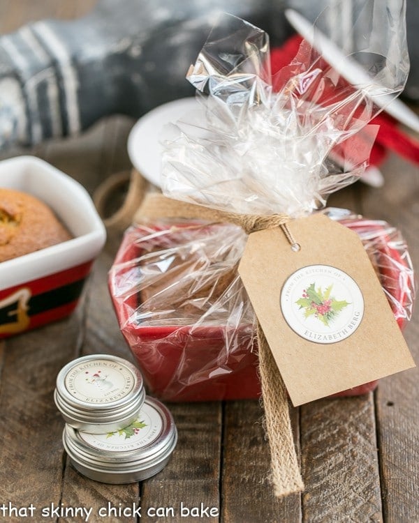 Mini Pumpkin Breads - Perfect for gifting throughout the holiday season! Mini Pumpkin Breads wrapped in cellophane with a festive gift card.