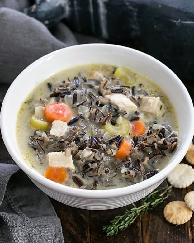Closeup of a bowl of wild rice soup from above.