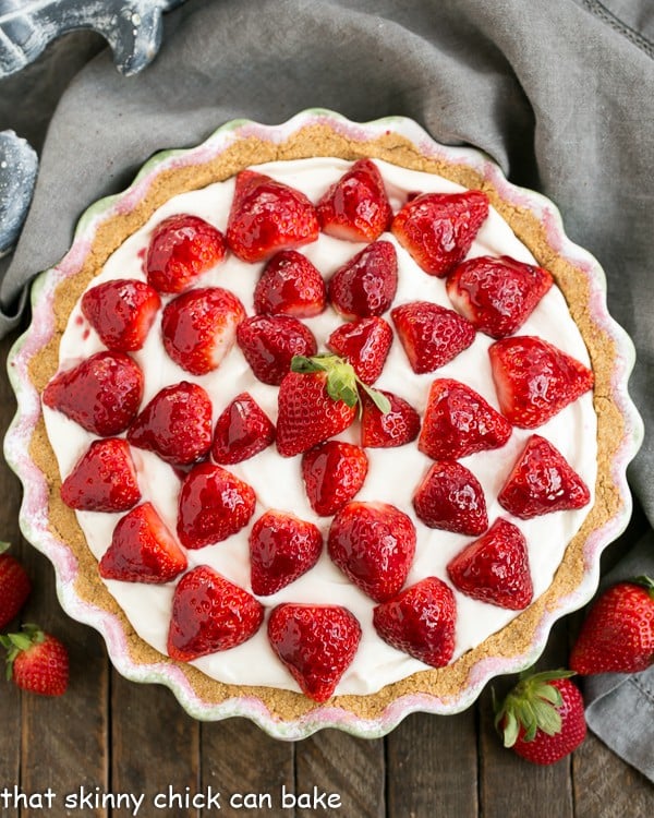 Overhead view of a Strawberry Cream Pie topped with berries.
