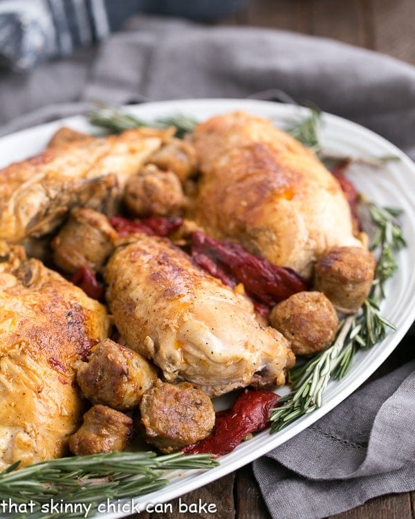 Chicken Scarpariello with Sausage on a platter garnished with fresh rosemary.