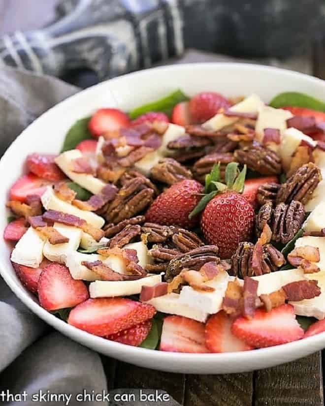 Strawberry Bacon Brie Salad - A spectacular combination of ingredients tossed in a strawberry balsamic vinaigrette Strawberry Bacon Brie Salad in a white serving bowl.
