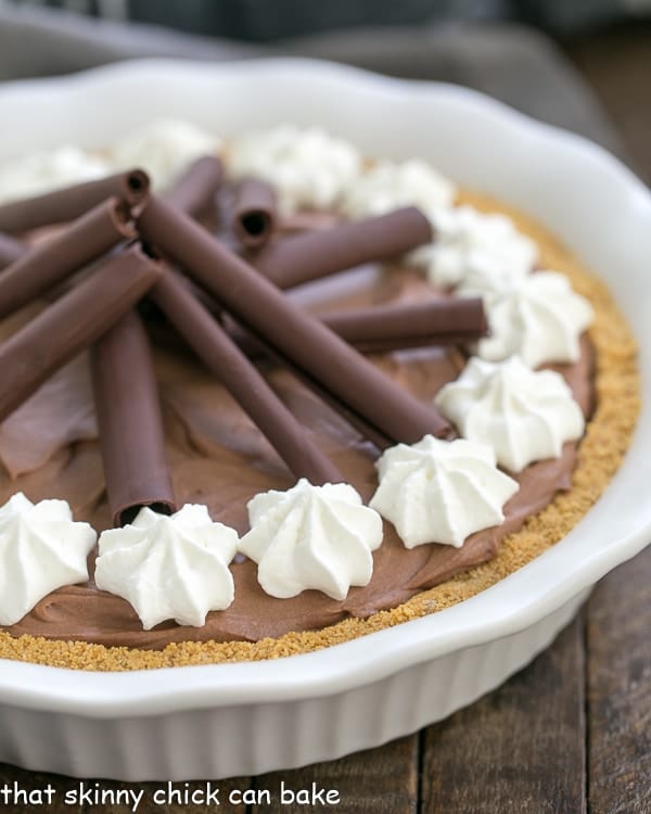 Chocolate Cream Pie - A dreamy, rich chocolate filling nestled in a graham cracker crust! Chocolate Cream Pie in a white ceramic pie plate.