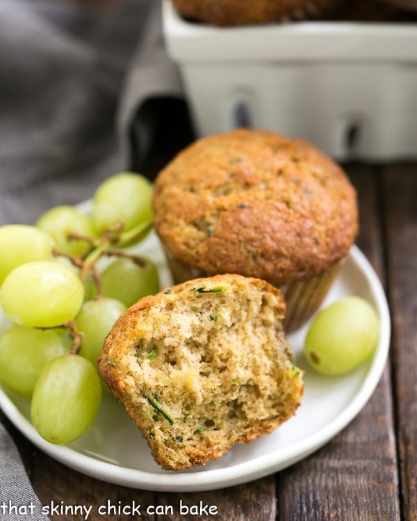 Cinnamon Zucchini Muffins on a small white plate with green grapes.