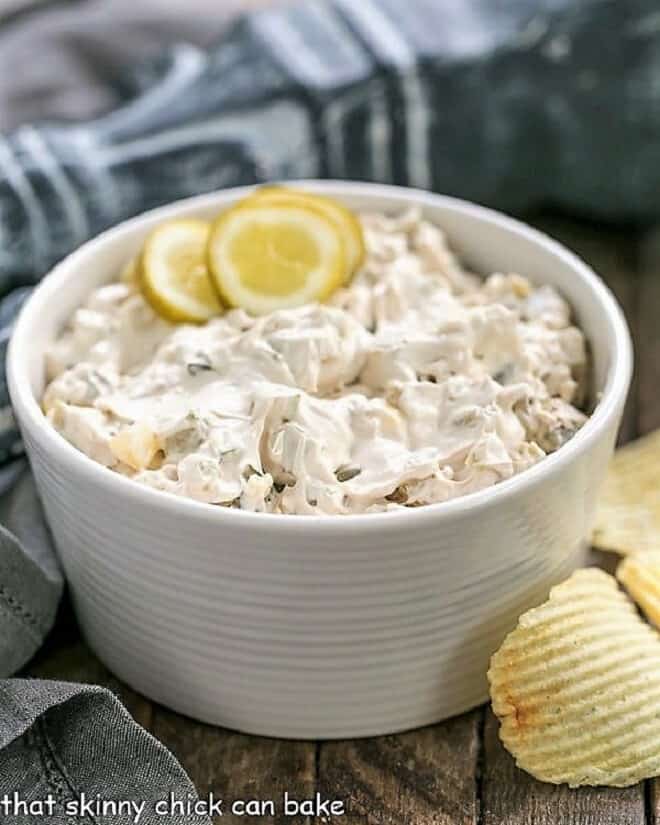 Easy Dill Pickle Dip in a white bowl garnished with pickle slices.