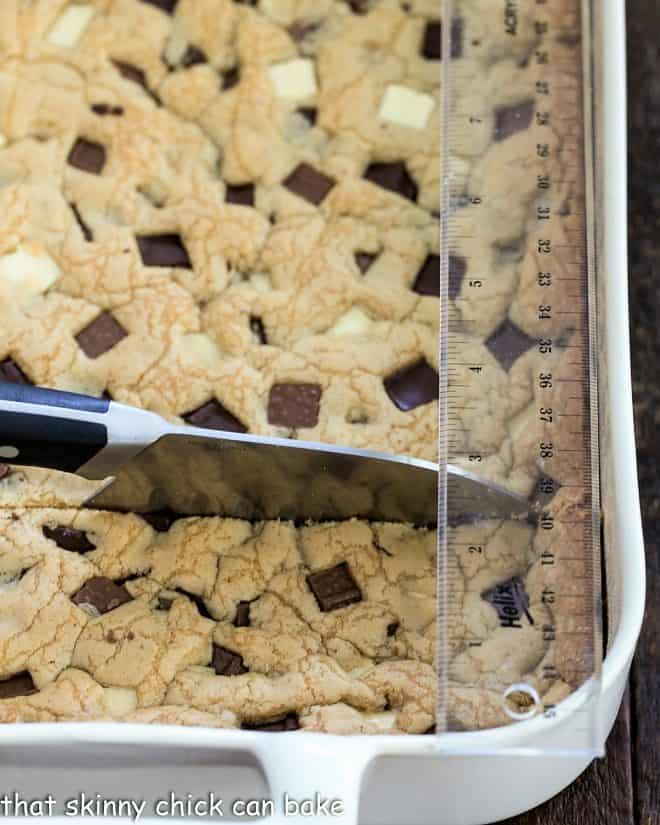 Bar cookies with a knife and ruler that are ready for precision cutting.