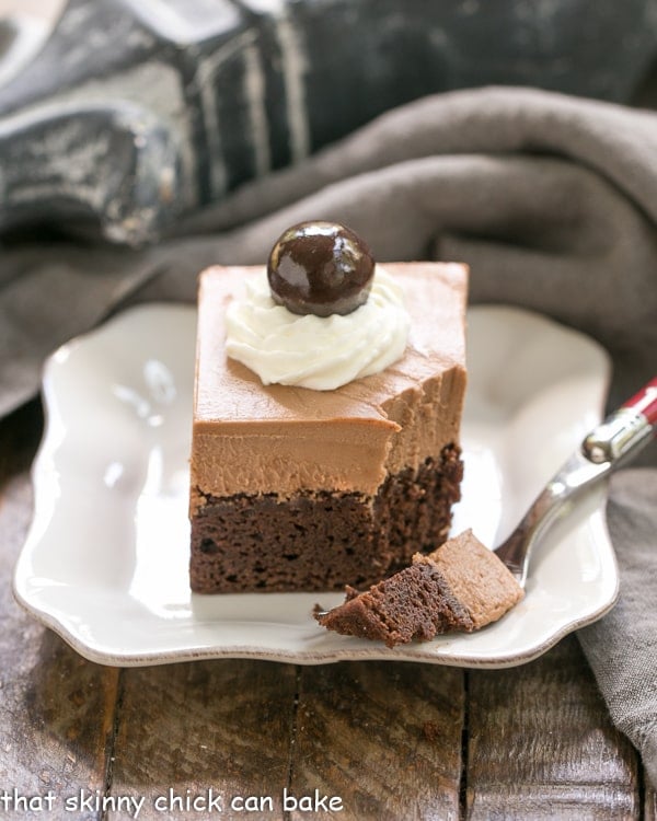 French Silk Pie Brownies - A spectacular 2 in one dessert that's a cinch to prepare! French Silk Pie Brownies with a forkful removed and resting on a square white plate