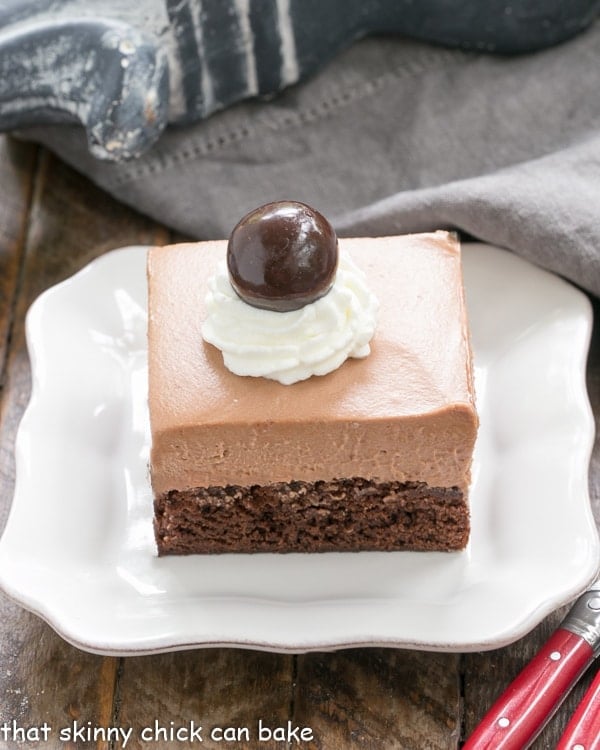 French Silk Pie Brownies - A spectacular 2 in one dessert that's a cinch to prepare! French Silk Pie Brownies on a white ceramic plate