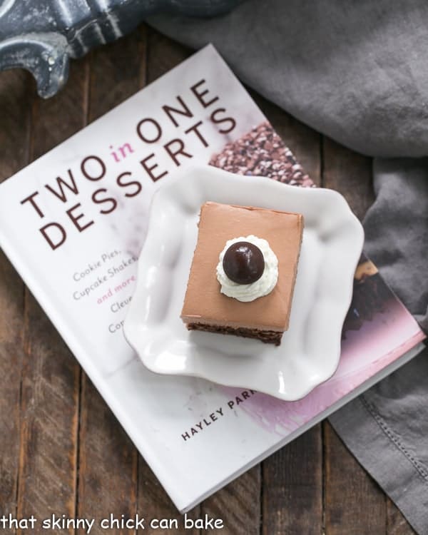 French Silk Pie Brownies - A spectacular 2 in one dessert that's a cinch to prepare! French Silk Pie Brownies on a plate resting on a cookbook