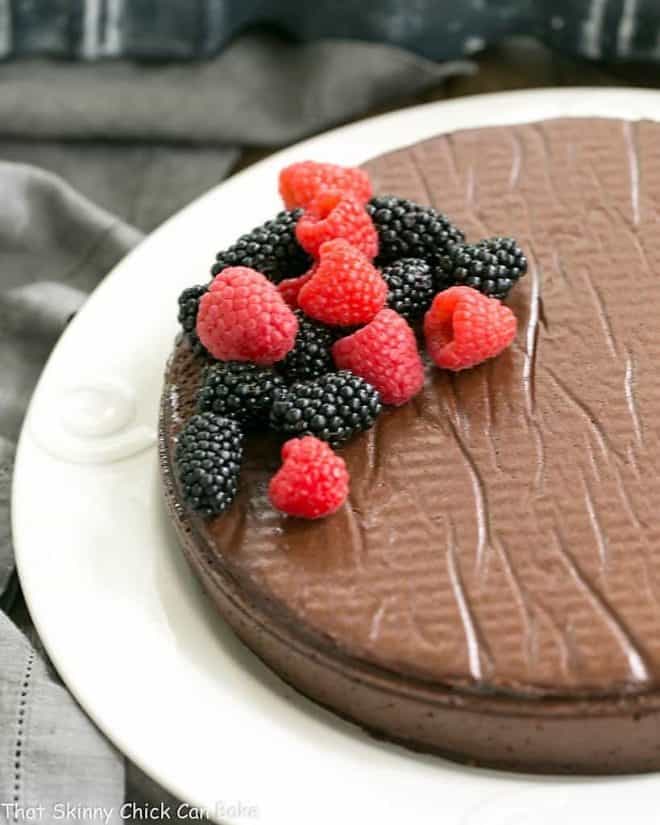 Flourless Cake Chocolate from Princeville Hotel - 5 simple ingredients make for one decadent, outrageously delicious dessert! Flourless Cake Chocolate from Princeville Hotel on a white serving plate