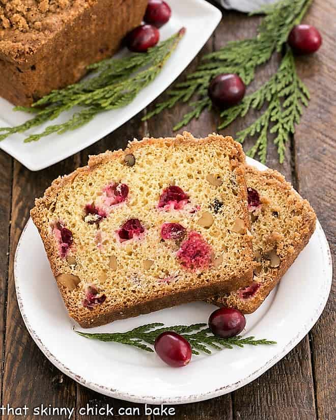 Streusel Topped Cranberry Orange Walnut Bread slices on a small white plate.