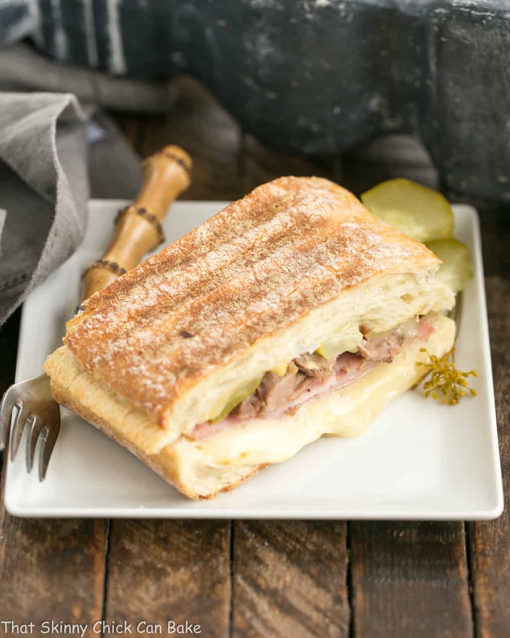 Ciabatta Cubano Sandwich Recipe - An out of this world "grilled pork and cheese" sandwich! Ciabatta Cubano Sandwich on a square white plate.