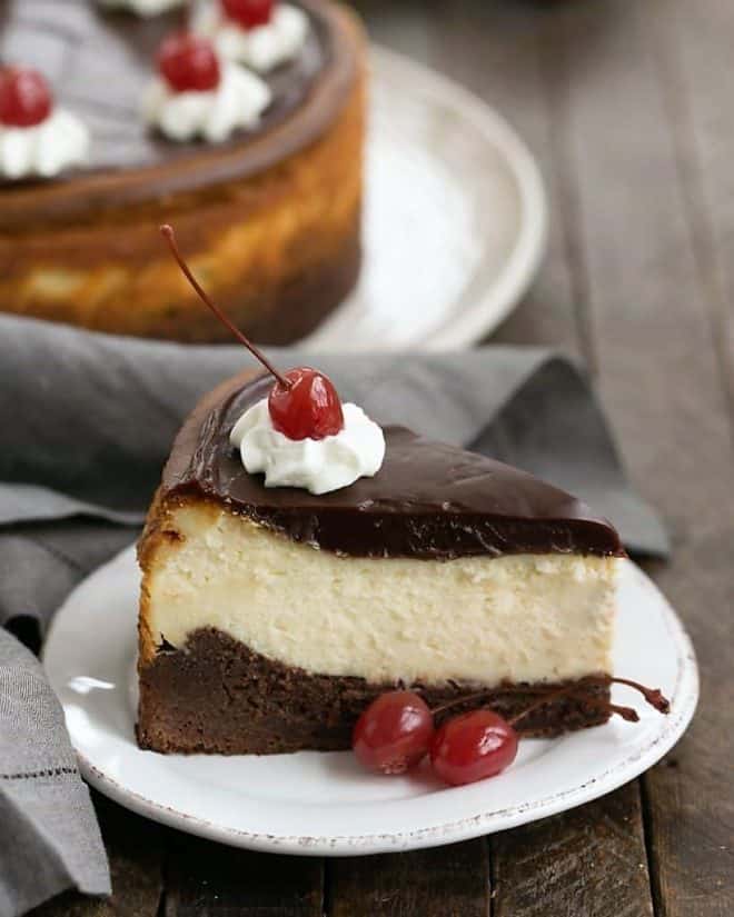 Slice of Hot Fudge Brownie Cheesecake on a white dessert plate.