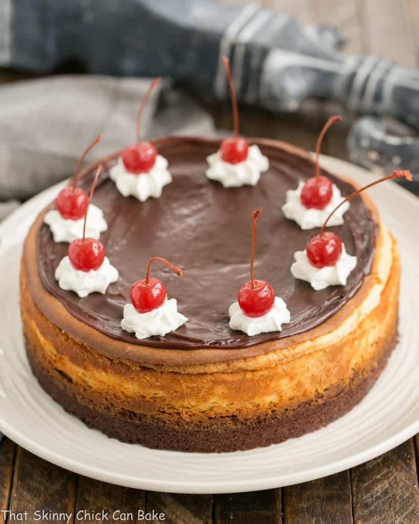 Hot Fudge Brownie Cheesecake on a white cake plate.