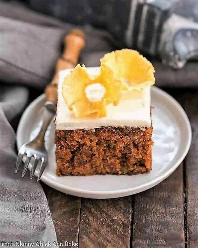 Slice of the best carrot cake on a round white plate