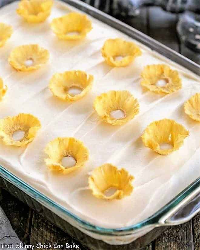 One layer carrot cake topped with cream cheese frosting and pineapple flowers