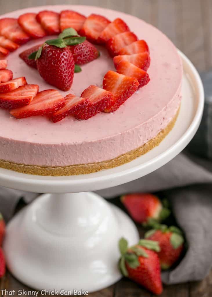View of top of No-Bake Strawberry Cheesecake on a cake stand