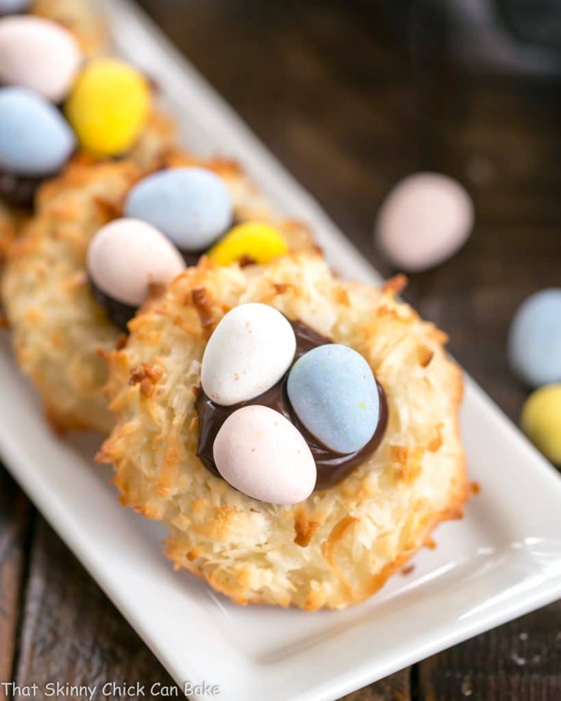 Coconut Macaroon Easter Nests lined up on a thin white tray.